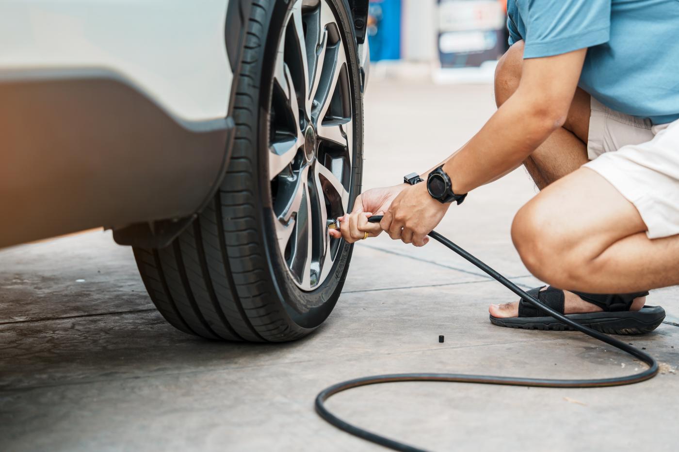 Man inflating car tires